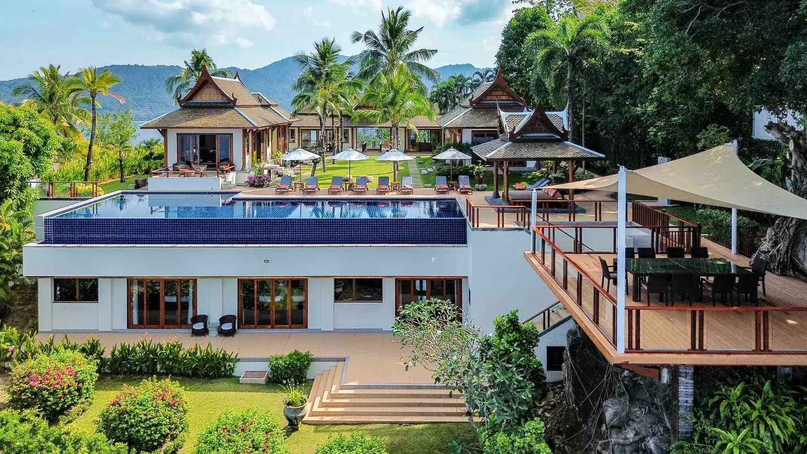 Aerial oceanfront villa with infinity pool and dining deck