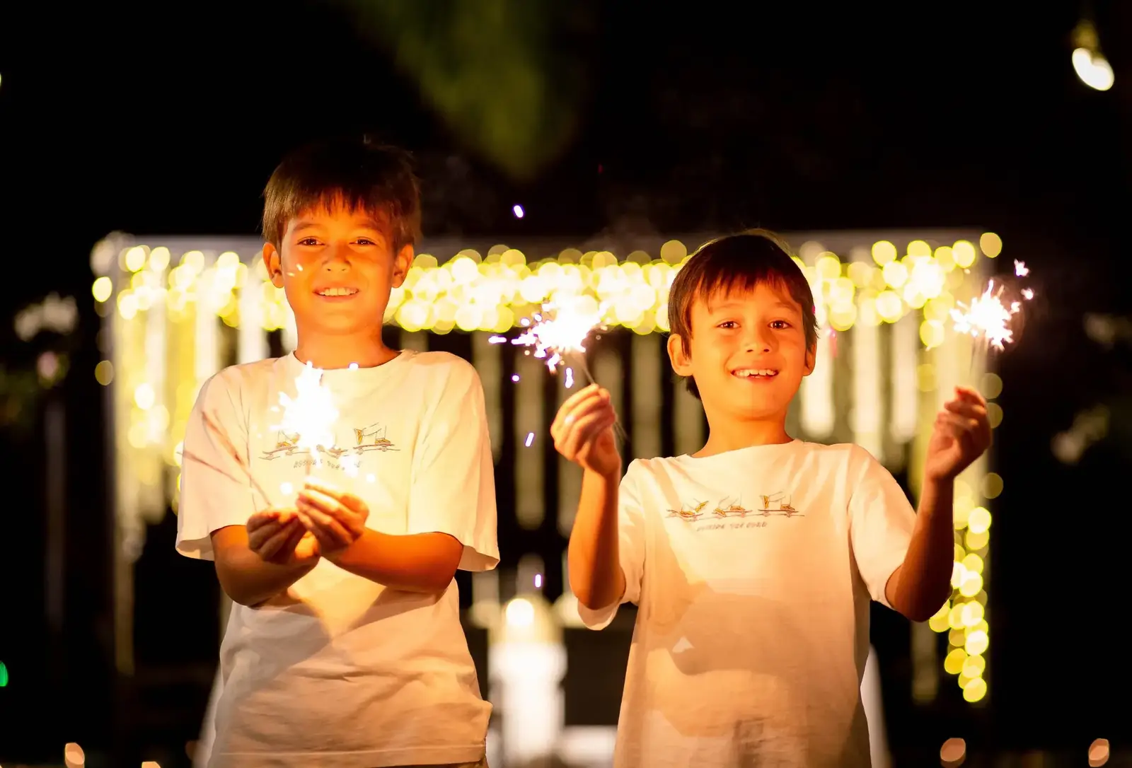Children with sparklers at evening celebration