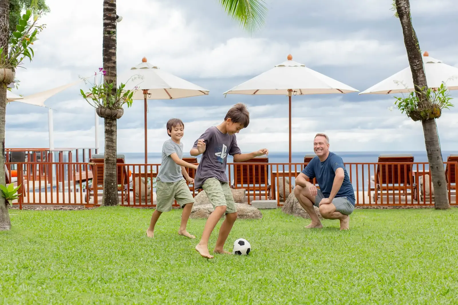 Family football on the oceanfront lawn