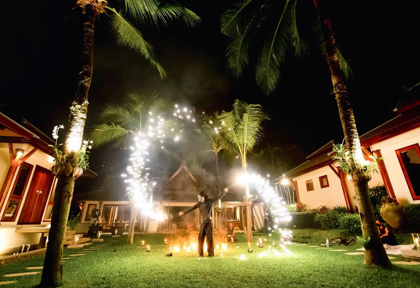 Fire dancers on the central lawn at night