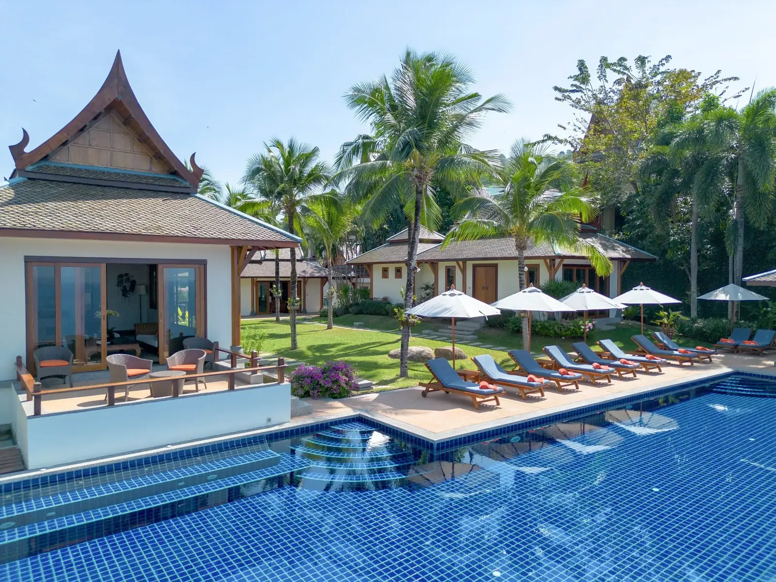 Infinity pool with guest pavilion and lawn