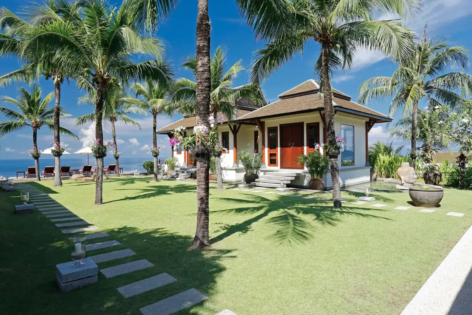 Lawn and tropical garden beside guest pavilion