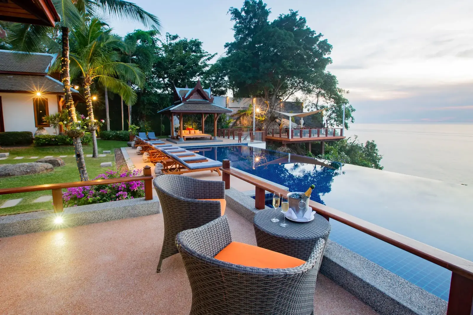 Poolside sala at dusk with champagne