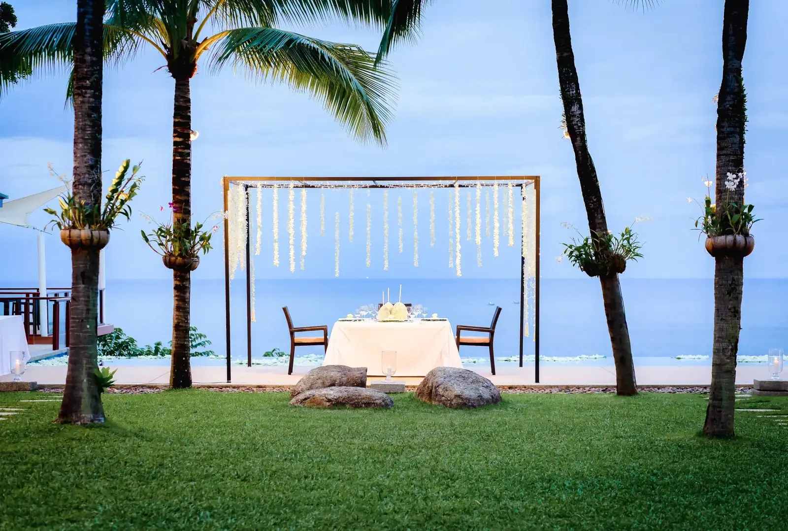 Romantic dinner table on the lawn by the Sea