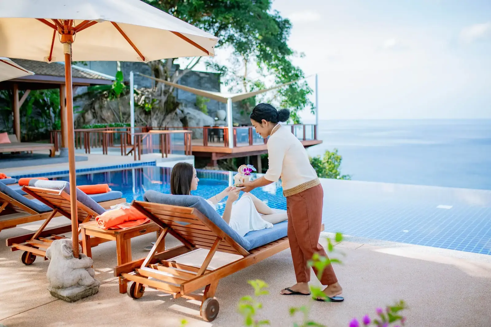 Staff service by the infinity pool