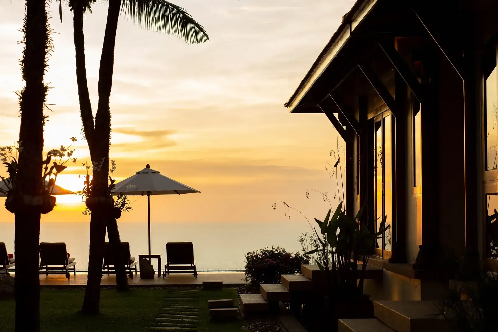 Sunset through the palms beside the pavilion