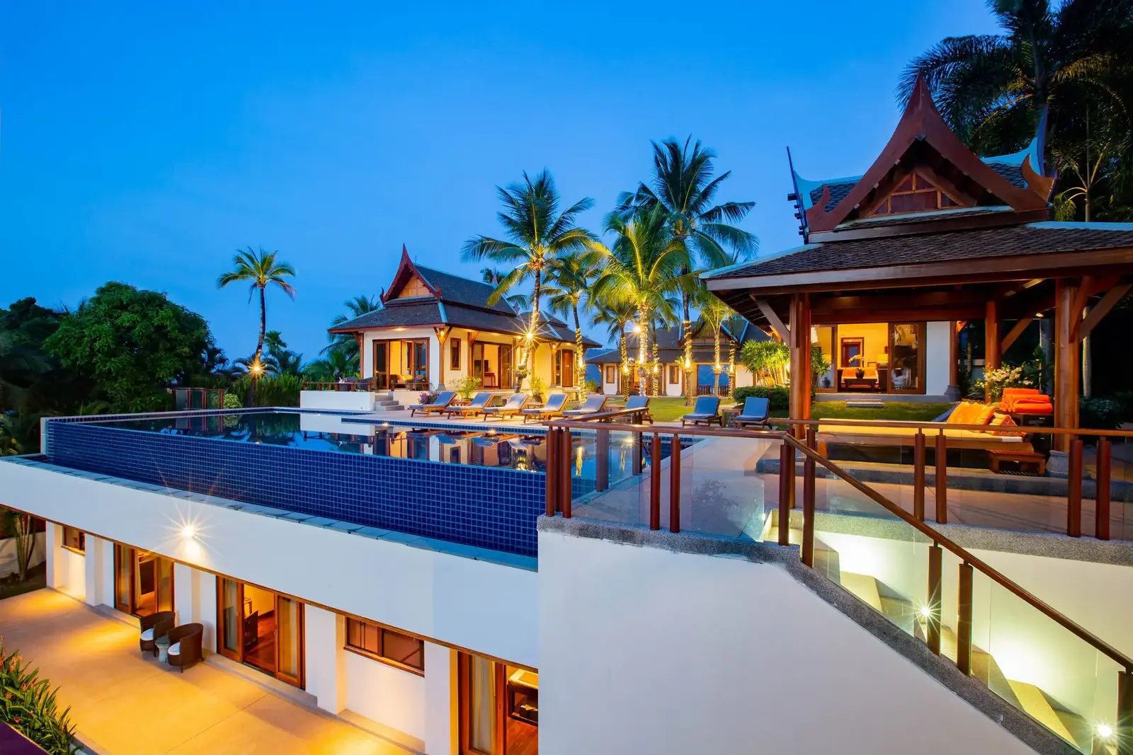 Villa and infinity pool illuminated at blue hour